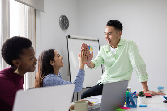 Workplace success celebration with high five