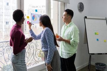 Diverse team brainstorming with market analysis chart