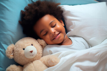 a darkskinned boy sleeps sweetly in bed with a toy bear in his arms under the blanket