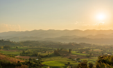 Naklejka premium Scenic mountain landscape and bright sunrise or sunset sky over the horizon. Natural skyscape background