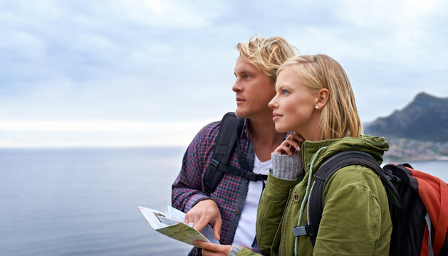 Couple, thinking and map by ocean for hiking, direction or location on outdoor adventure together in nature. Young man and woman reading tour or travel guide for route, path or destination on hike