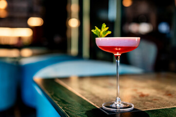 alcohol cocktail in a glass stands on a table in a bar or restaurant