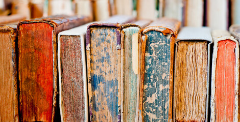 Old books background. Stack of books in a row.