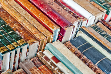 Old books background. Stack of books in a row.