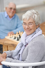 Chess, game and happy portrait with old people together in retirement to relax with happiness. Elderly, man and woman outdoor with a smile for winning competition, checkmate or activity with strategy