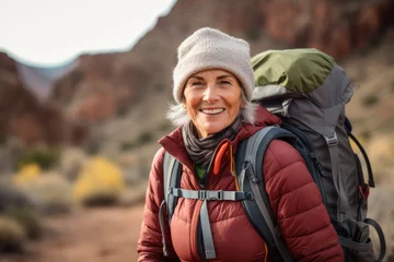 Poster Happy senior woman hiking in the mountains. Grand Canyon National Park, Arizona, USA © Nerea