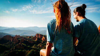 Two young people at sunset looking out over a mountain landscape.
Las Medulas natural park in spain