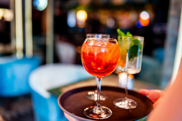 glasses alcohol cocktail set on a waiter tray in bar