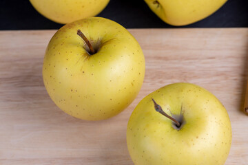 Naklejka na ściany i meble yellow ripe apple with cinnamon on the table