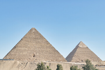 Fototapeta na wymiar GIZA,EGYPT - JUNE 12 2023: Giza pyramid complex includes three pyramid complexes known as Pyramid of Khufu,Karfe and Menkaura and Egyptologists believe that they were built around 2560