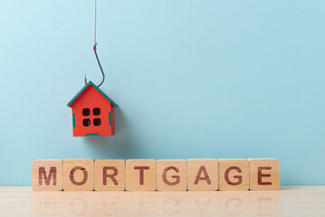 Red House Hanging Above MORTGAGE Text on Wooden Blocks over Blue Background - 741461065