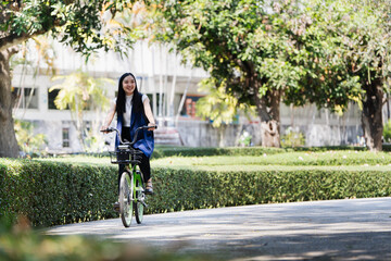 Fototapeta premium Professional Business woman with bike in the morning walking in the street to work. Eco friendly
