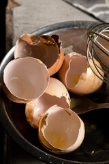 Cracked eggshells and whisk on the table, space for text
- 741462468