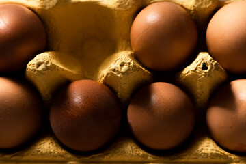 Close up view of brown eggs in yellow paper box
- 741462821