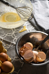 Cooking with eggs, cracked egg shells, used kitchen utensils on the table
- 741462888