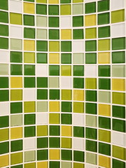 Ceramic mosaic tiles are installed on curved cement walls in bathrooms, kitchens or swimming pools. Wall-mounted ceramic, light green-yellow,checkered pattern. Design geometric patterns with grid wall