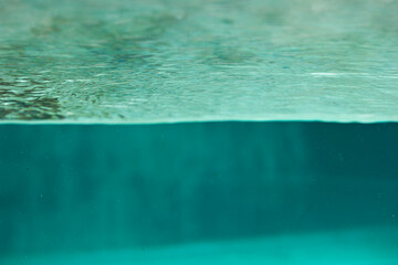 turquoise background water close-up in a glass pool
