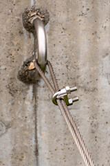 Steel turnbuckle and sling steel or Steel Wire Rope Sling and metal cable clamp connected with screw bolt. Device for adjusting the tension or length of cable on a blue sky background. Copy space.