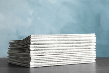 Stack of newspapers on blue background. Journalist's work