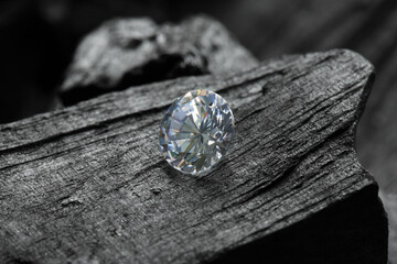 Beautiful shiny diamond on coal, closeup view
