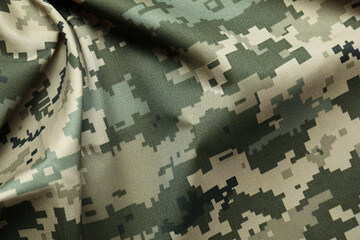 Texture of crumpled camouflage fabric as background, top view