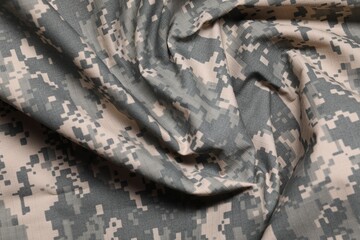 Texture of crumpled camouflage fabric as background, top view