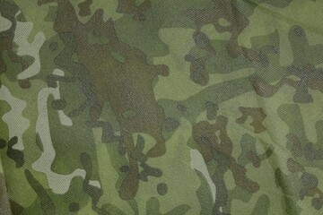 Texture of camouflage fabric as background, top view