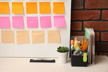 Business process planning and optimization. Workplace with colorful paper notes and other stationery on table