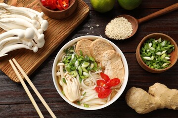 Delicious ramen with meat and ingredients on wooden table, flat lay. Noodle soup