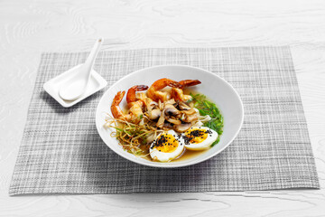 Ramen soup with noodles, egg, shrimp and mushrooms. Asia food.