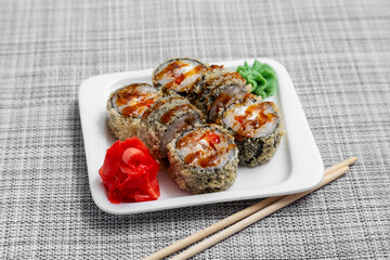 Sushi, fried rolls with eel and teriyaki sauce.