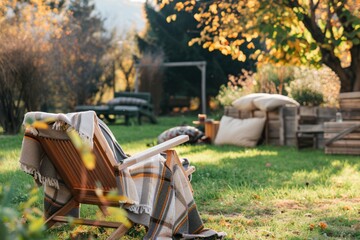Outdoor garden wooden furniture at autumn nature, green grass. Nobody at home backyard with chair, lounge. Relax at outside terrace with blankets, pillows at retro, vintage decoration.