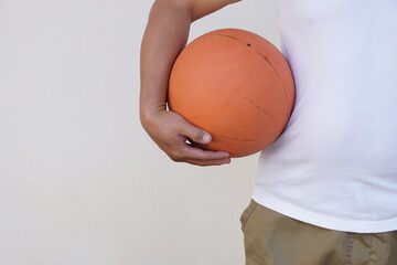 Close up man holds orange basketball. Concept, Sport equipment. Exercise for health. Healthy lifestyle.Work out makes strong of body.           