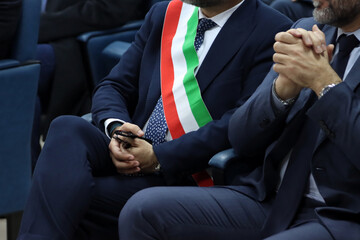 Close-up on the tricolor band of the Italian mayor. Italian politics, mayor elections