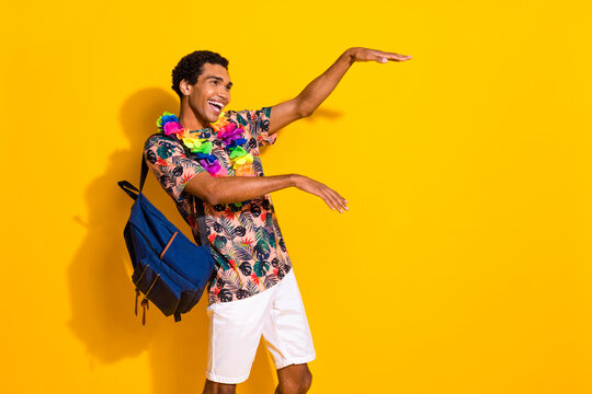 Photo of boogie woogie party guy t shirt has chill vibe dance in hawaiian necklace and backpack isolated over yellow color background