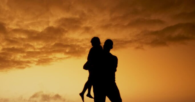 Father, child and lift in sunset with silhouette, spin and airplane games with clouds in nature on holiday. Person, kid and bonding with love, care and family at dusk for outdoor vacation with sky