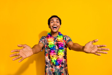 Photo of funky friendly guy dressed print t-shirt inviting you havaii party isolated yellow color...