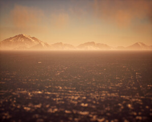 Frozen lake with snow mountains in mist under sky with some clouds.