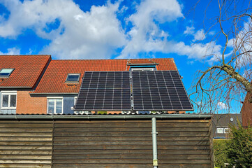 solar panels on the roof of a shed in the garden