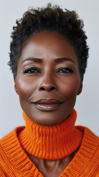 Beautiful confident older senior African American woman of old age posing for portrait. Mature adult lady black model on background. Close up face. Skin care and aging process concept .