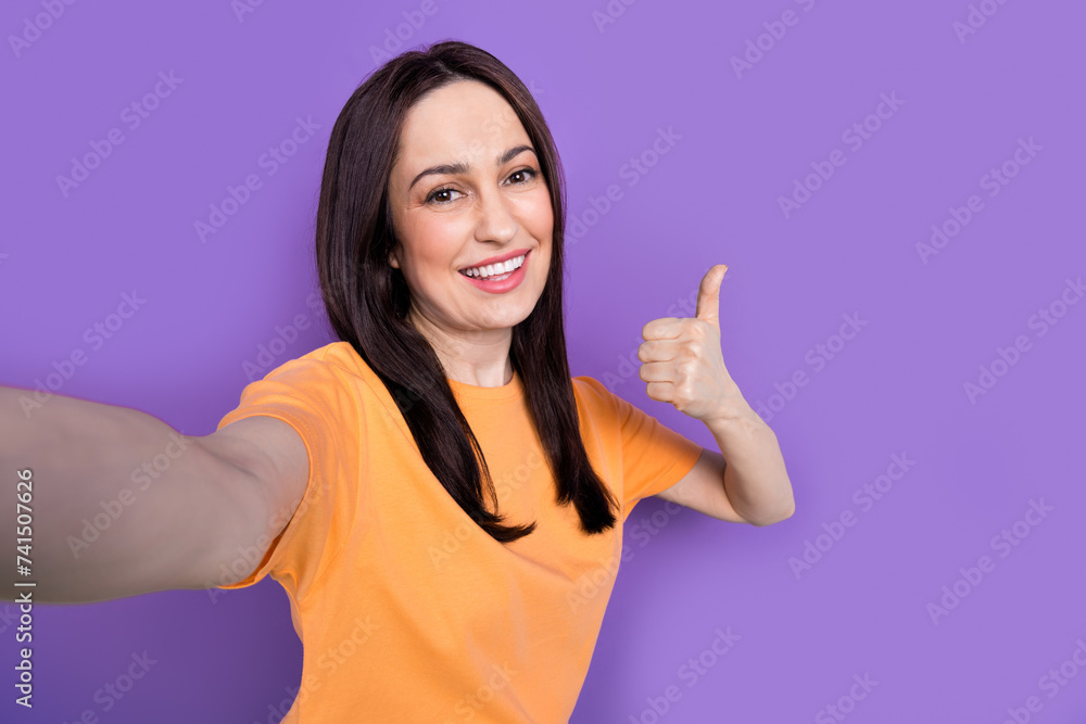 Sticker Selfie photo of mature age smiling cheerful business woman demonstrate good rate to her company isolated on violet color background