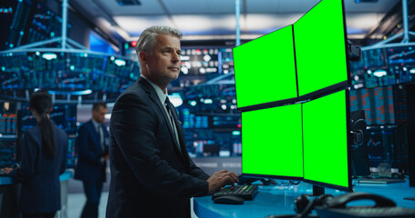 Financial Analyst Using a Desktop Computer with Multi-Monitor Workstation with Green Screen...