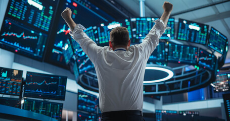 Excited Businessman Raises Hands and Punches Air while Celebrating Successful Deal. Stock Exchange...