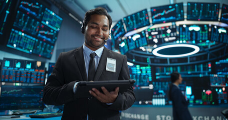 Portrait of a Young Indian Man Working in an International Stock Exchange Company: Happy Trader...