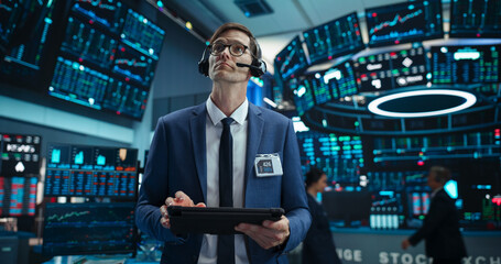 Portrait of a Successful Stock Exchange Manager Wearing Headphones, Working in Modern Office....
