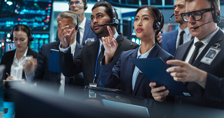 Team of Multiethnic Male and Female Traders Working in a Modern Stock Exchange Company. Asian,...