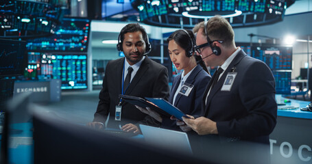 Team of Multiethnic Male and Female Traders Working in a Modern Stock Exchange Company. Asian,...