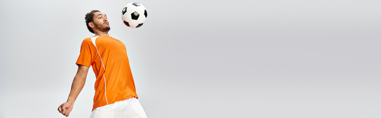 young handsome african american man in vivid comfy sportwear playing football actively, banner