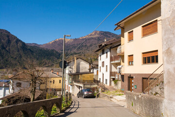 A residential street in the mountain village of Cedarchis near Arta Terme in Carnia, Friuli-Venezia Giulia, north east Italy - obrazy, fototapety, plakaty