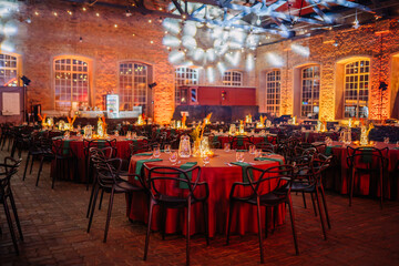 Riga, Latvia - February 16, 2024 -  an elegantly set event space with tables, chairs, and...